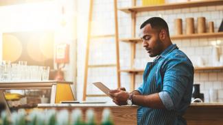 cafe-owner-looking-at-ipad